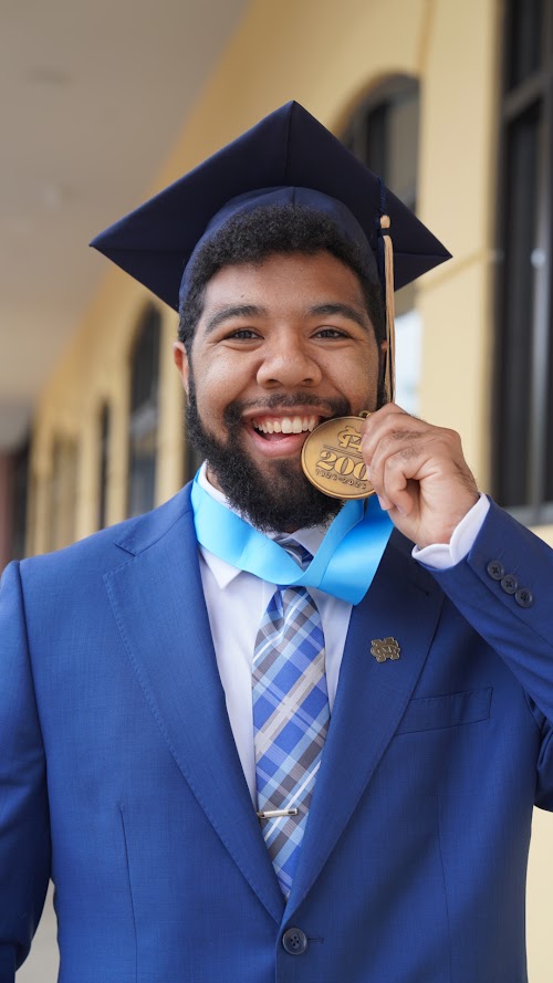 Graduate posing for a graduation portrait by The Palmetto Studios, New Orleans graduation photographer.