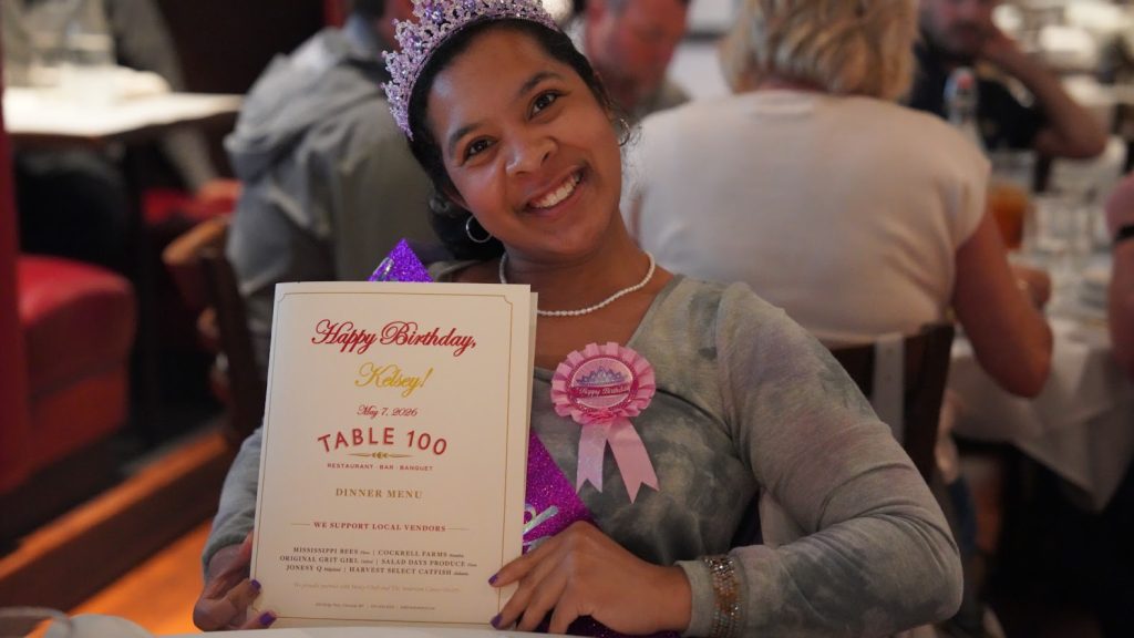 Smiling young girl holding a certificate in a children's celebration portrait by The Palmetto Studios in New Orleans.
